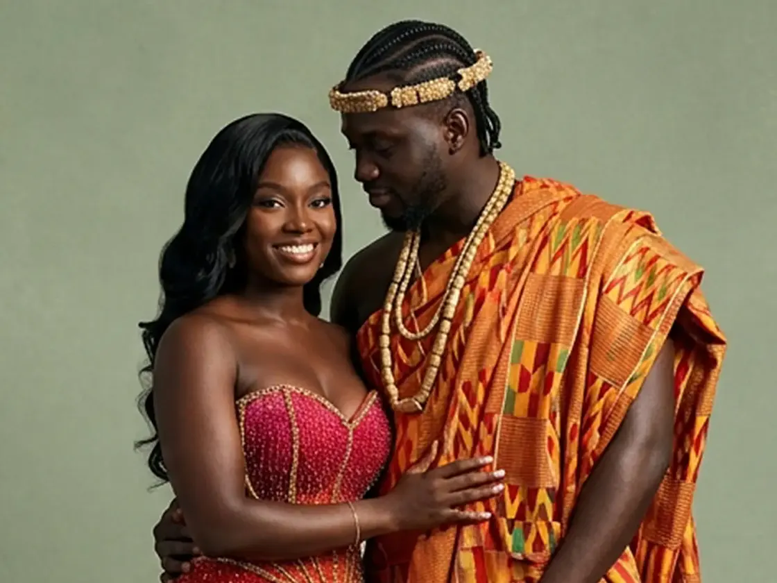 A couple in traditional Ghanaian kente and beaded regalia at their celebration